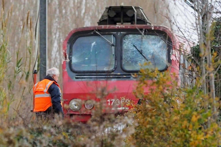 An employee inspects the SNCF regional train involved in a collision with a school bus in Millas, near Perpignan, December 15, 2017 