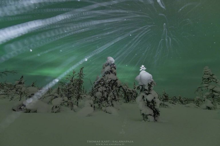Snowflakes and aurora borealis in northern Finland.