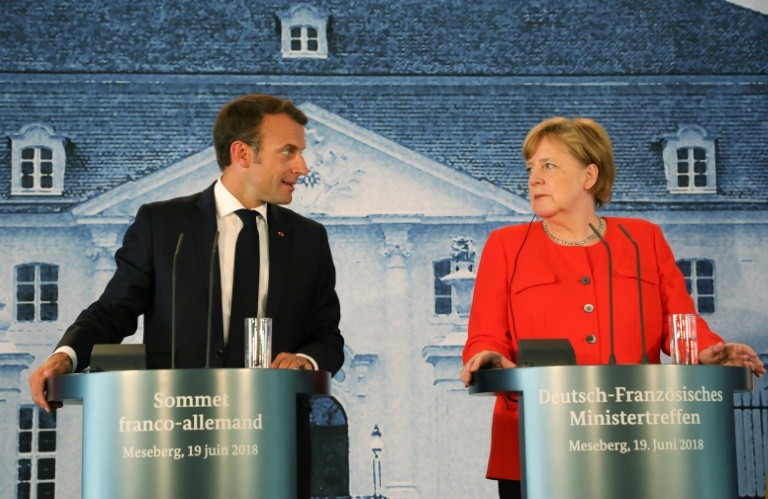 Macron and Merkel giving a press conference on Migrants and immigration