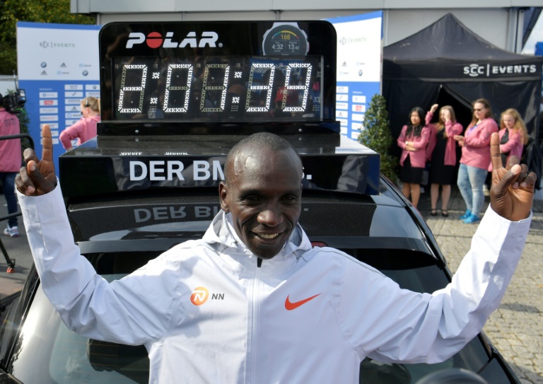 Kenyan Eliud Kipchoge poses in front of the official mark of his marathon world record, beaten in Berlin on September 16, 2018