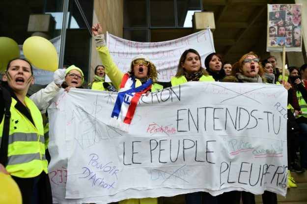 Yellow vests with a banner about Macron
