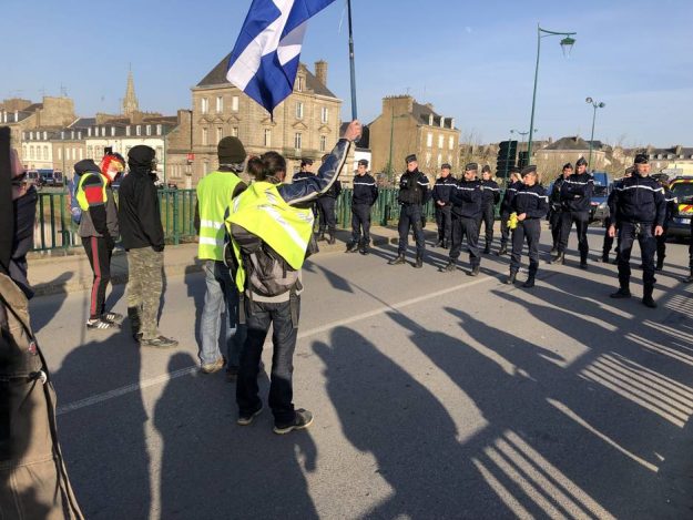 Protesters face police on the bridge near La Plaine, Pontivy. 