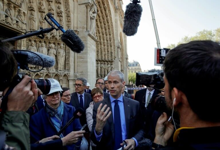 Franck Riester (C) speaks on the forecourt of Notre-Dame cathedral