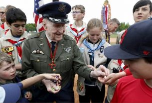 Former US pilot Gail Halvorsen - who participated in the Berlin Airlift - distributes sweets to members of a Berlin baseball team and US Scouts at a ceremony at the former Tempelhof Airport in Berlin May 11, 2019.