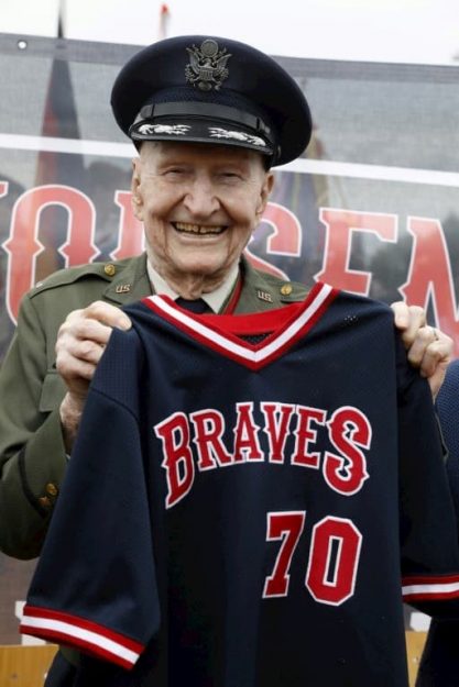 Gail Halvorsen poses with a jersey of the local Berlin Braves baseball team during a ceremony at the former Tempelhof airport in Berlin on 11 May 2019. 