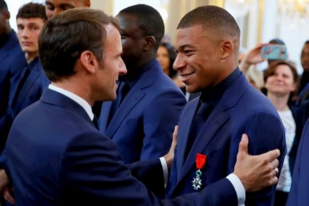 President Macron with Kylian Mbappé at the presentation of the Legion of Honor to the 23 French players at the Elysée on 4 June 2019.