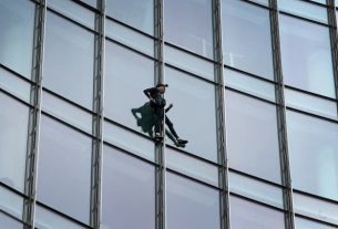French climber Alain Robert, nicknamed the "French Spiderman", during his climbing of the Skyper, a 42-story tower in Frankfurt, Germany, on September 28, 2019