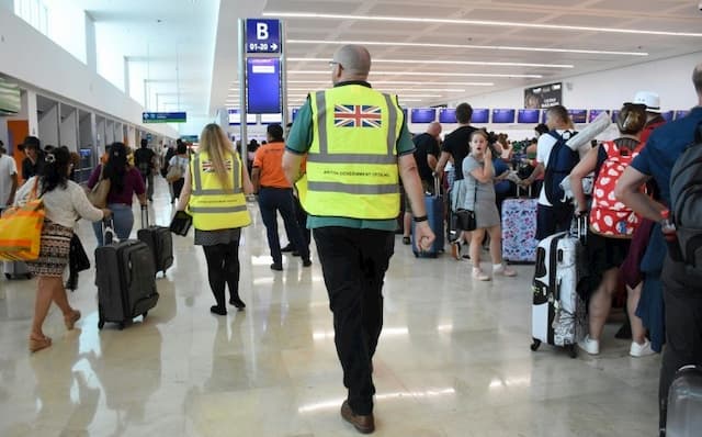 UK officials help Thomas Cook customers at Cancun airport in Mexico on September 23, 2019.