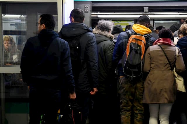 Passengers board a metro at the Gare du Nord on December 18, 2019.