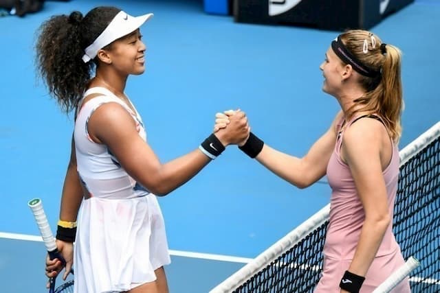 Naomi Osaka of Japan (g) shakes hands with Czech Marie Bouzkova after beating her in the 1st round of the Australian Open on January 20, 2020 in Melbourne.