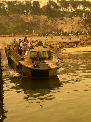 People are evacuated by boat from the city of Mallacoota on January 3, 2020.