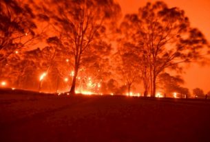 The sky reddened by flames on December 31, 2019 near the town of Nowra, New South Wales, Australia.