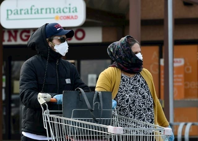 Residents, with a protective mask on their faces, are shopping in a supermarket in Casalpusterlengo, on February 23, 2020 in Italy.