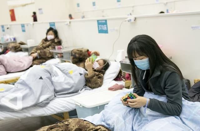 A patient solves a rubik’s cube at a temporary hospital in Wuhan