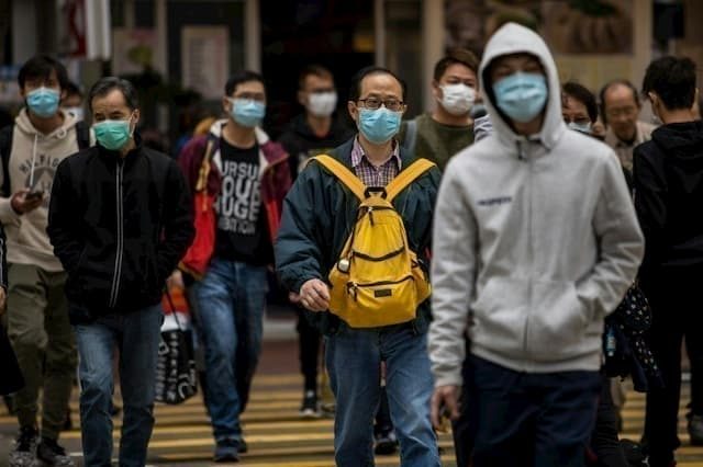 Hong Kong residents in the city streets on February 9, 2020.