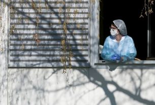 A member of the nursing staff rests for a few minutes at the window of the Emile Muller hospital in Mulhouse, on March 24, 2020