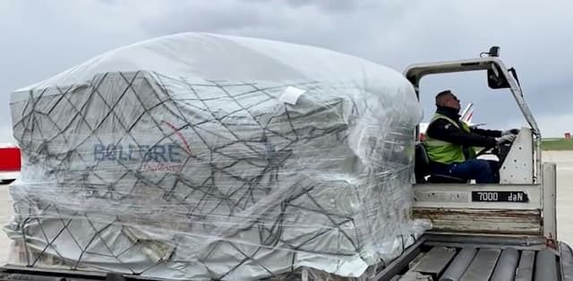 A cargo of protective masks is unloaded from a cargo plane arriving from China, March 29, 2020 at the Paris airport of Roissy-Charles de Gaulle.