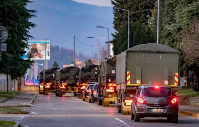 Army trucks full of bodies are seen driving through the streets of Italy