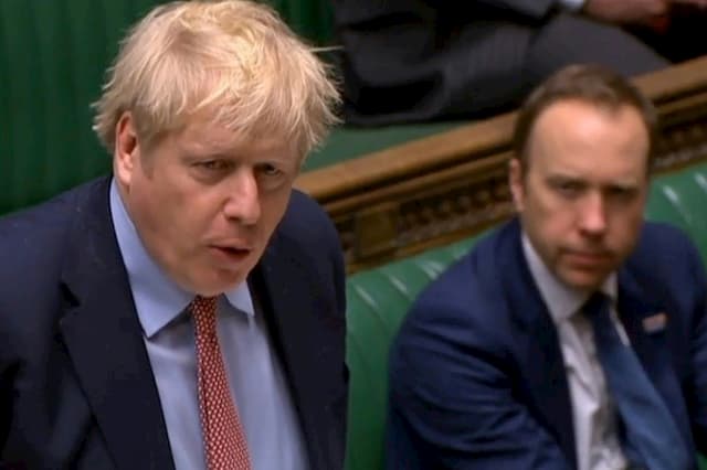 Prime Minister Boris Johnson and his Minister of Health Matt Hancock, on a video capture of the British Parliament, in London on March 25, 2020.
