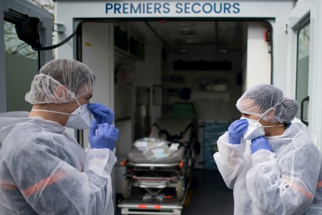 Civil protection carers take charge of a migrant infected with Coronavirus Covid-19, on April 7, 2020 in Saint-Herblain (Loire-Atlantique)