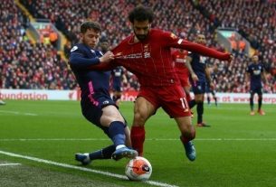 Liverpool midfielder Mohamed Salah (d) wrestling with Bournemouth defender Jack Simpson during the Premier League match at Anfield on March 7, 2020.