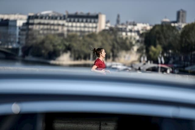 A jogger crosses a bridge spanning the Seine in Paris, April 10, 2020.