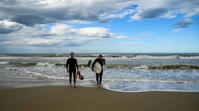 Surfers on the beach in Rimini on May 11, 2020 in Italy