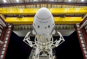 The Crew Dragon capsule on top of a SpaceX Falcon 9 rocket, horizontal, exiting a hangar at the Kennedy Space Center, Florida, on May 21, 2020.