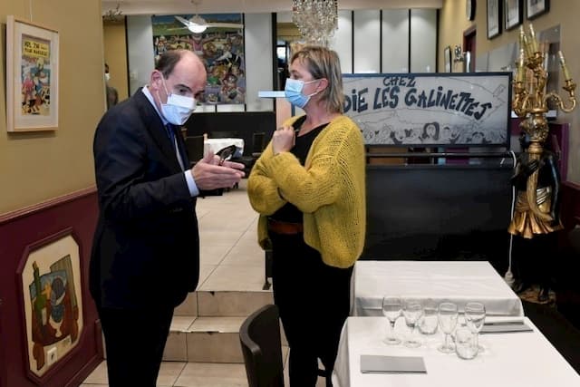 Prime Minister Jean Castex speaks with the owner of the restaurant "Chez Madie les galinettes" in the Old Port of Marseille, October 24, 2020