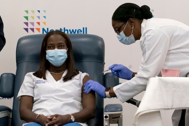 ICU nurse Sandra Lindsay became the first American to receive Pfizer’s Covid vaccine on Monday. She was given the shot by her colleague Dr Michelle Chester at the Long Island Jewish Medical Center in Queens, New York 