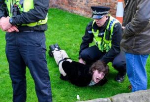 Protester Patrick Thelwell is arrested after throwing an egg near King Charles III