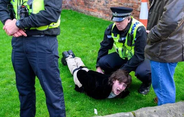 Protester Patrick Thelwell is arrested after throwing an egg near King Charles III